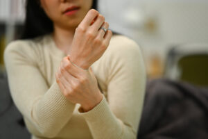 Hand holding hand to illustrate arthritis differences management